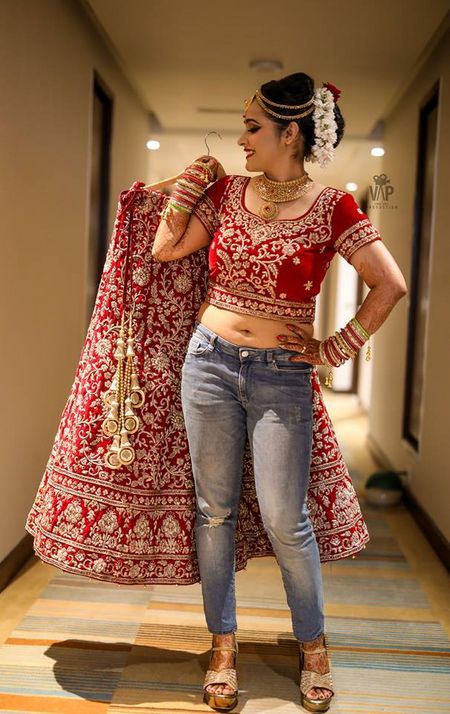 Cute bride in jeans and red lehenga
