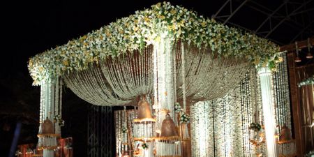 Photo of white and green flower decorated stage