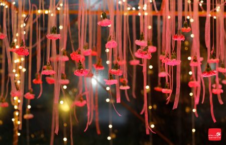 Photo of Hanging strings with pink and red pompoms