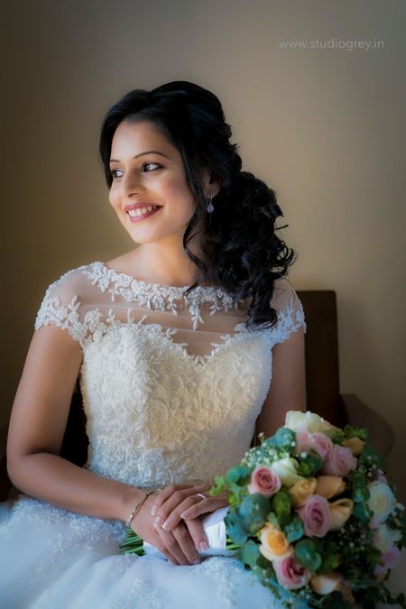 Bride posing in a beautiful white gown on her wedding day