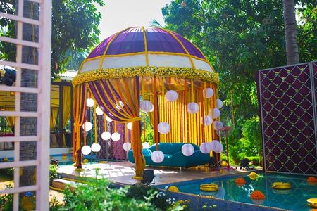 Colourful mandap with hanging lantern curtains