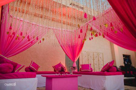 Photo of Wedding decor in bright pink with hanging floral strings