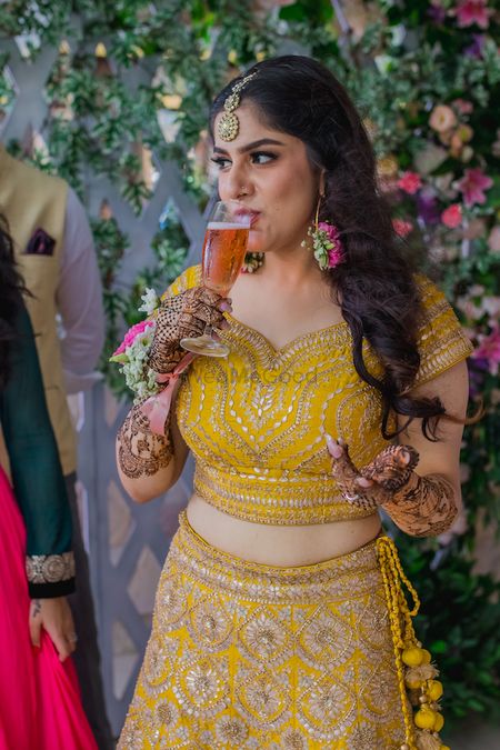 Photo of bride drinking juice on mehendi or haldi photo