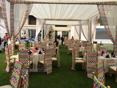 Photo of colorful stripes chairs with white theme mehendi decor