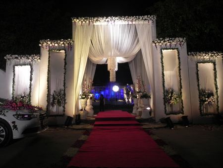Photo of white theme wedding entrance decor
