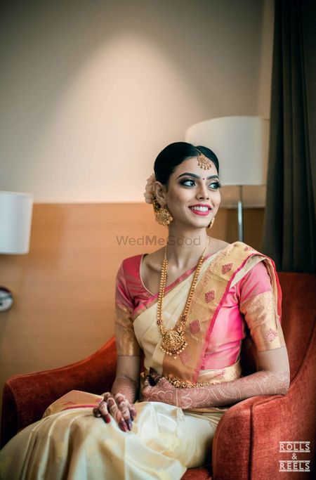Photo of Unique gold kanjivaram saree with pink blouse