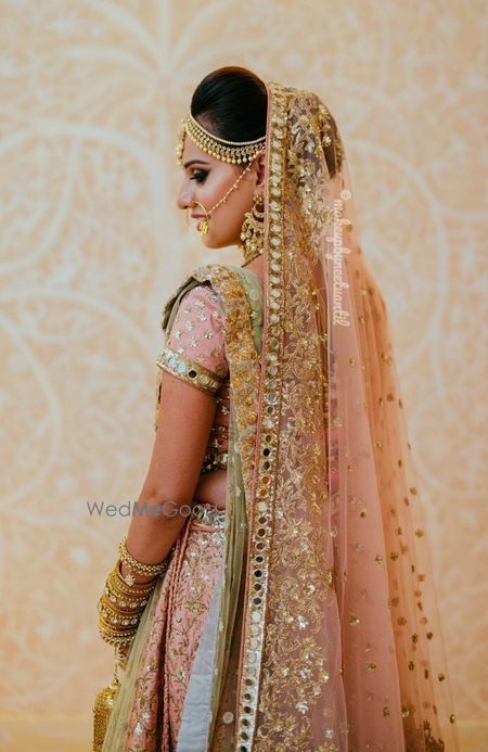 Photo of Wedding day bridal portrait in peach lehenga