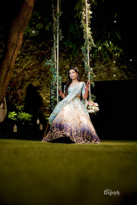 Bride on swing with leaves mehendi 