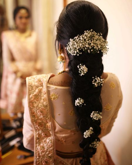 Photo of bridal mehendi hairstyle with babys breath braid