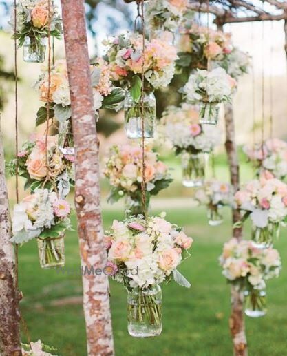 Peach and white flowers in mason jars for engagement decor 