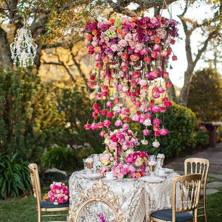 Photo of Pretty table setting with cascading floral chandelier