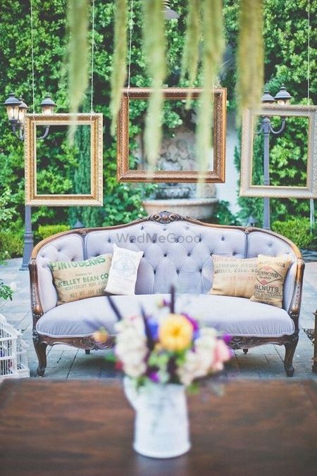 Engagement decor with sofa and hanging frames 