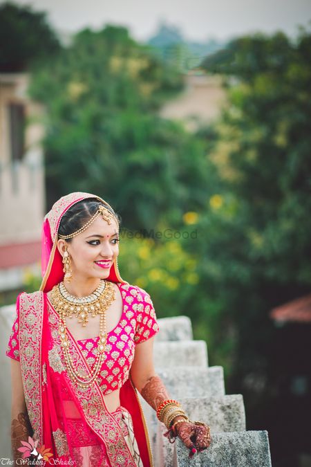 Bride in pink with traditional gold jewellery