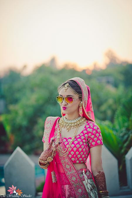Cool bride in reflector sunglasses wearing pink lehenga