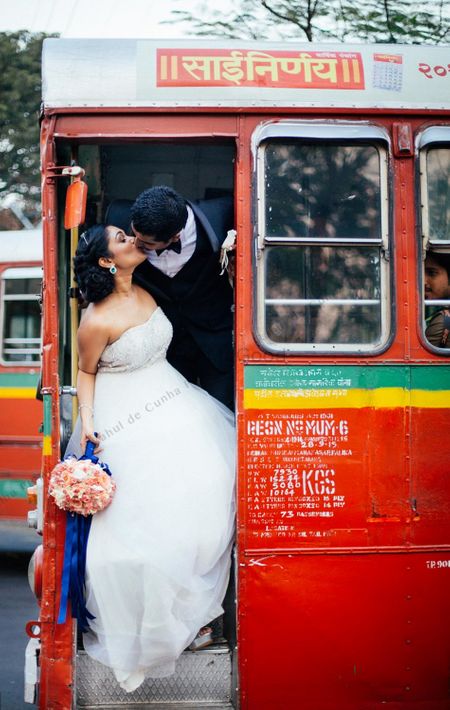 Couple kissing in best bus post wedding shot
