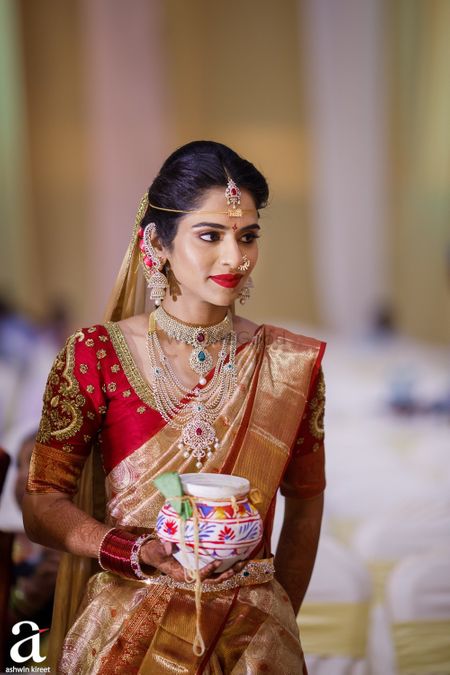 Photo of south indian bride in red and gold kanjivaram and diamond jewellery