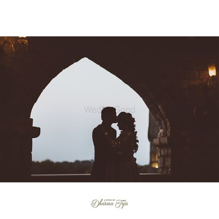 Photo of A groom kissing her bride on the forehead during an outdoor pre-wedding shoot.
