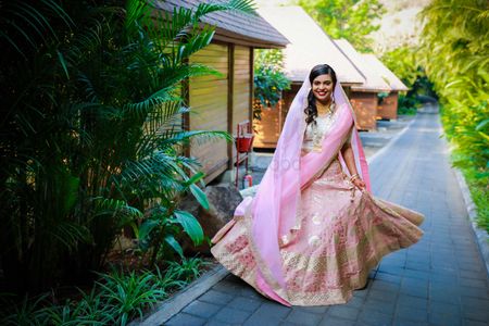 Photo of wedding day bridal shot in light pink lehenga