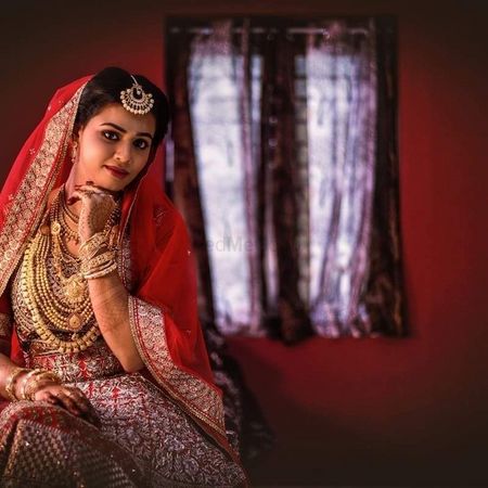 Photo of Pretty bridal portrait at home in a red bridal lehenga
