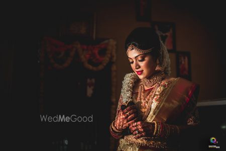 Photo of Gold south indian bridal look with floral braid