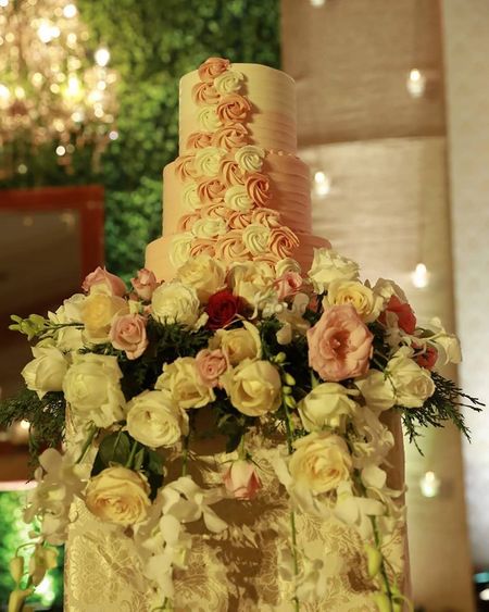 Photo of A three-tier wedding cake with elegant floral decor