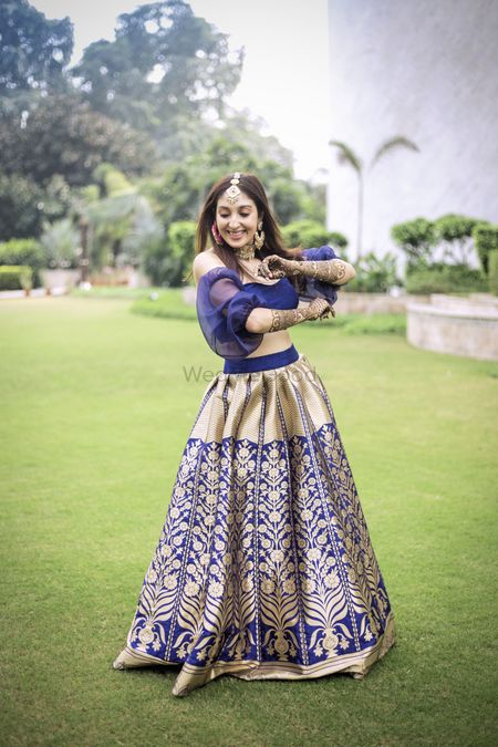Unique blouse design with blue and gold brocade lehenga 