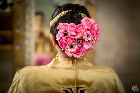 Bright pink bridal bun with big flowers 