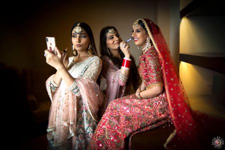 Photo of cute bride getting ready shot with her bridesmaids