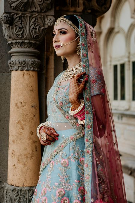 A bride in blue with contrasting pink dupatta 