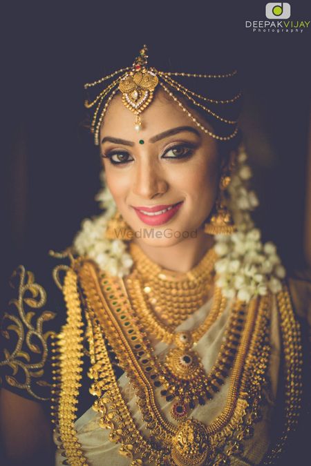 South Indian bride with layered necklaces in gold 