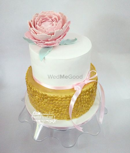 Photo of Elegant two tier wedding cake in white and gold
