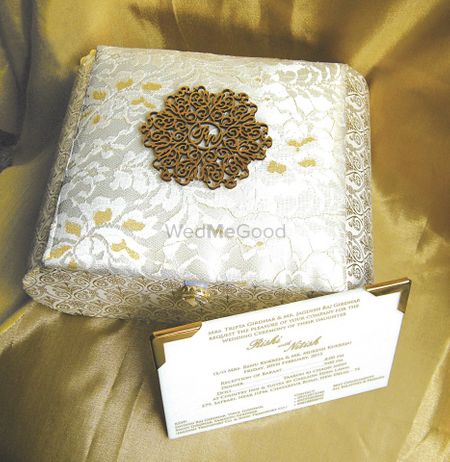 Photo of White and gold wedding invitation box