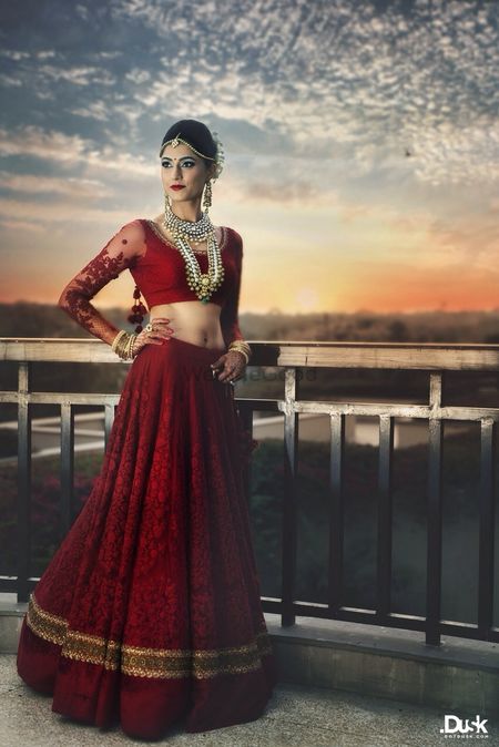 red bridal lehenga with threadwork and pearls in red