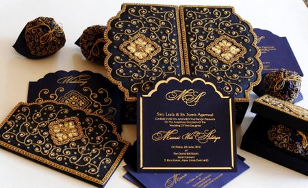 Photo of navy blue and gold wedding cards