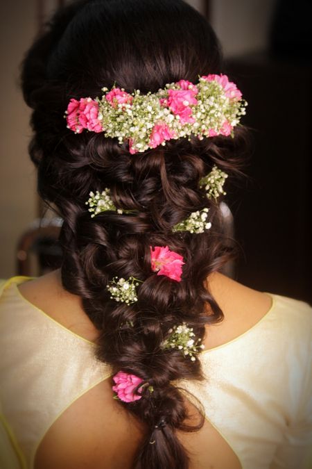 Braided hairstyle with flowers and babys breath