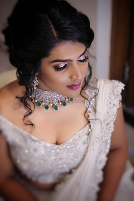 Shimmery eye makeup for engagement with contrasting necklace