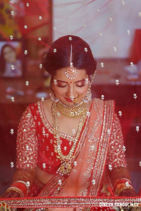 Bridal portrait idea with red net dupatta 