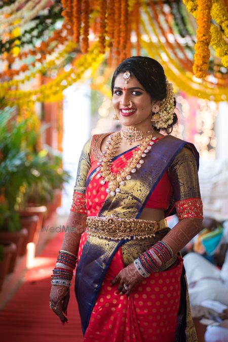 Photo of South Indian bride in orange and purple saree
