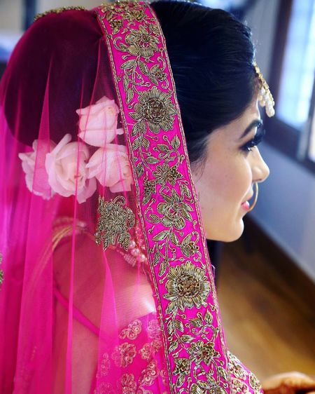 Hairstyle for pink lehenga with white flowers