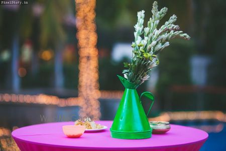 Green teapot with floral arrangement