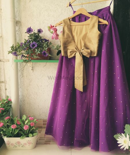 Light purple lehenga with gold blouse with a bow