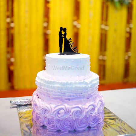 Photo of White and lavender small wedding cake with couple cake topper