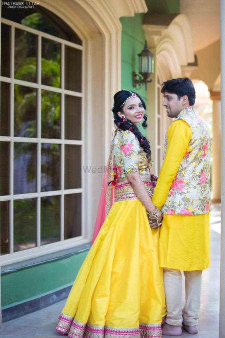 Bride and groom in coordinated yellow and floral outfit
