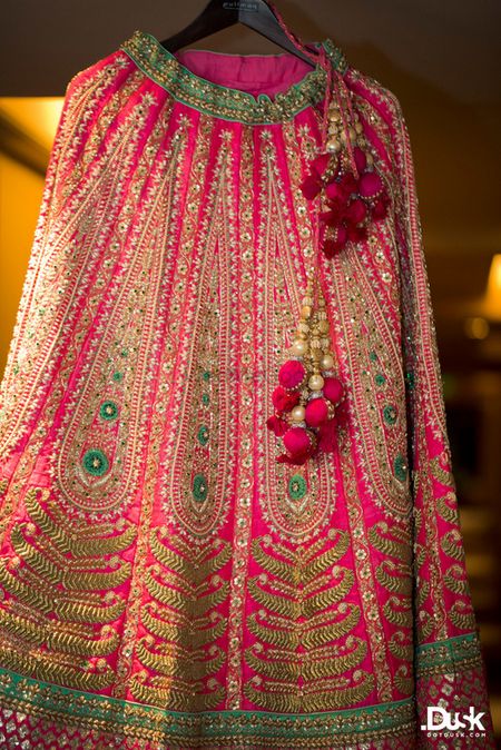 Photo of Hot Pink and Sea Green Lehenga on a Hanger