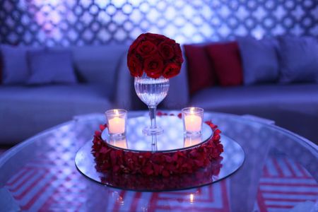 Photo of Candle lit red roses table centrepiece decor