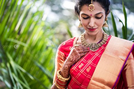 Simple South Indian bridal look in red saree and temple jewellery