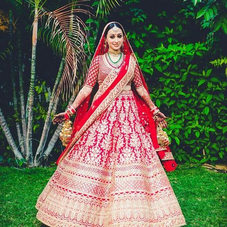 Red and gold bridal lehenga with floral motifs