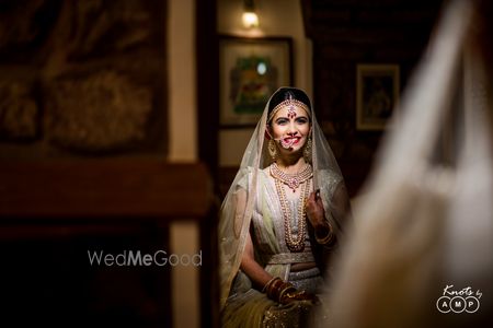 Bride looking at herself in mirror getting ready 