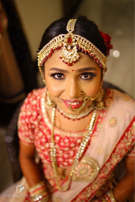 Pretty red and gold mathapatti for wedding day 