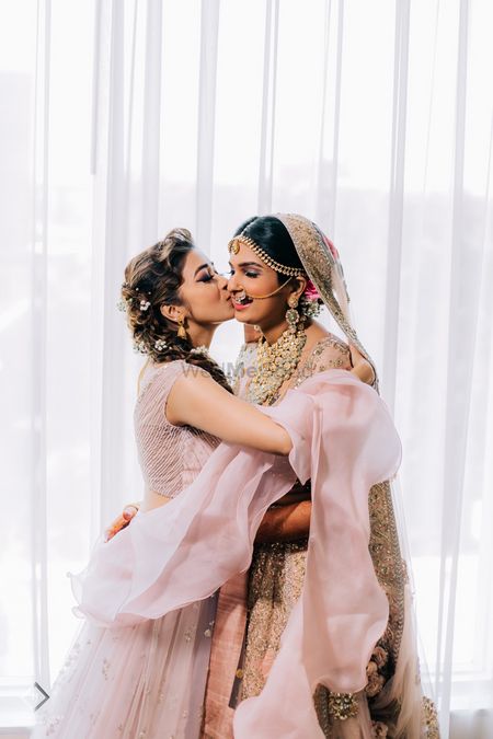 Photo of A cute bride and sister moment on her wedding.